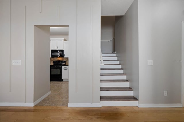 staircase featuring wood-type flooring