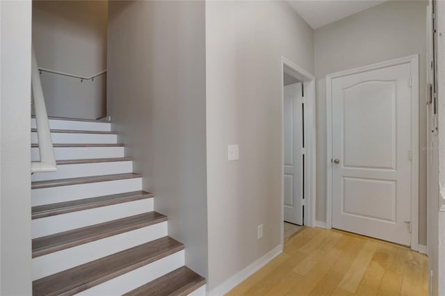 stairs featuring hardwood / wood-style floors