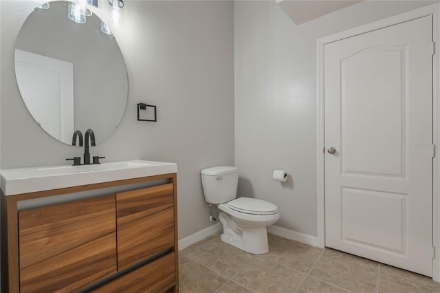 bathroom featuring tile patterned flooring, vanity, and toilet