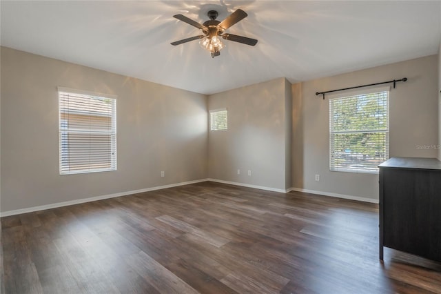 unfurnished room featuring dark wood-type flooring and ceiling fan