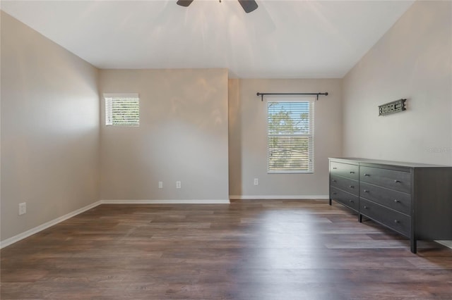 interior space with dark wood-type flooring, a wealth of natural light, and ceiling fan