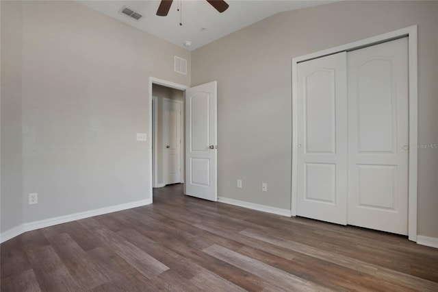 unfurnished bedroom with wood-type flooring, a closet, ceiling fan, and vaulted ceiling