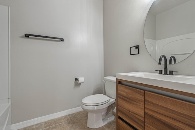 bathroom featuring tile patterned flooring, vanity, and toilet