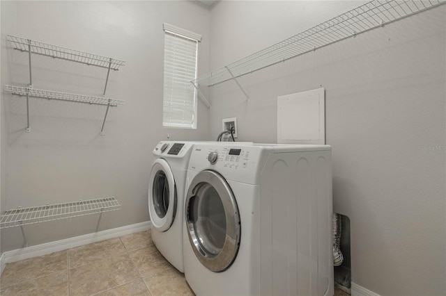 laundry area featuring light tile patterned floors and washer and clothes dryer