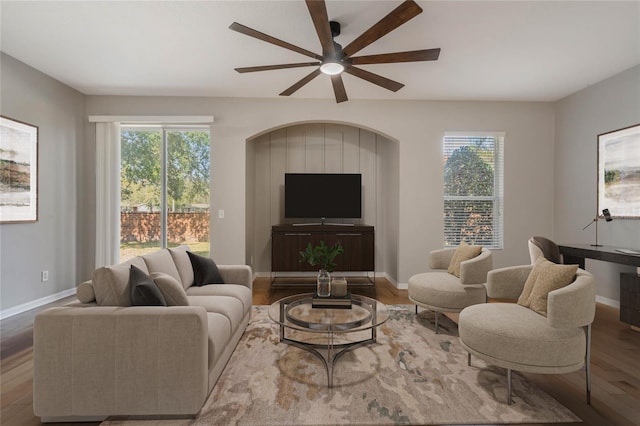 living room with ceiling fan, a healthy amount of sunlight, and wood-type flooring