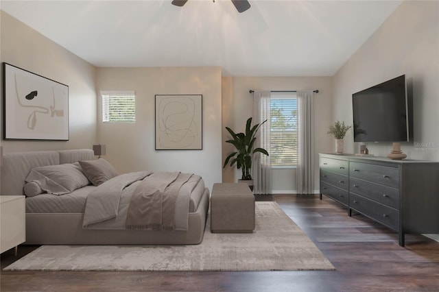 bedroom with lofted ceiling, dark hardwood / wood-style floors, and ceiling fan