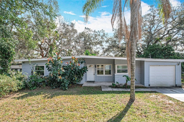 single story home featuring a garage and a front lawn