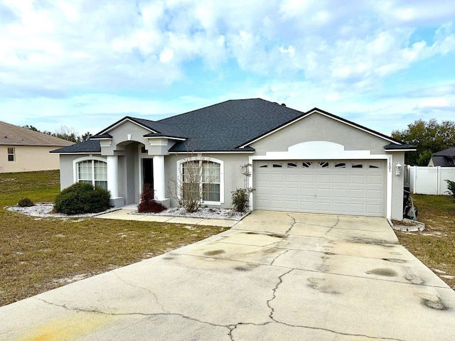 view of front facade featuring a garage and a front yard