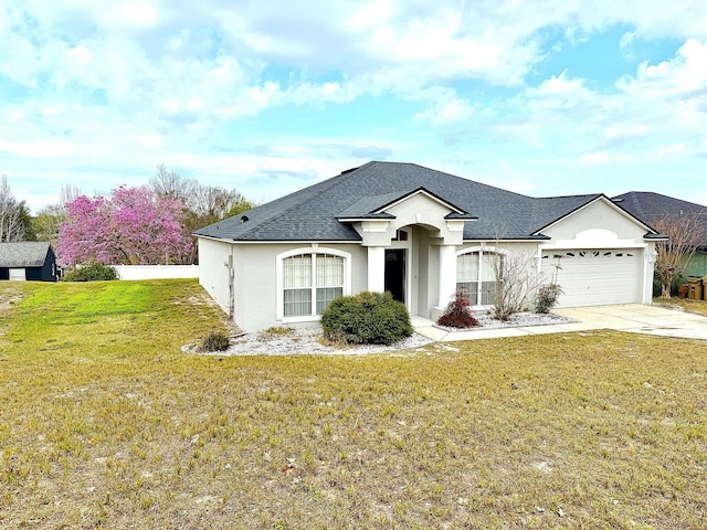 view of front facade with a garage and a front lawn