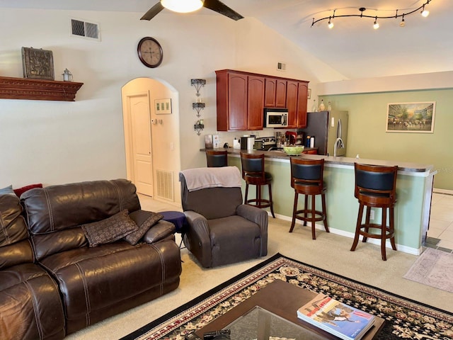 living room featuring sink, rail lighting, ceiling fan, light carpet, and vaulted ceiling