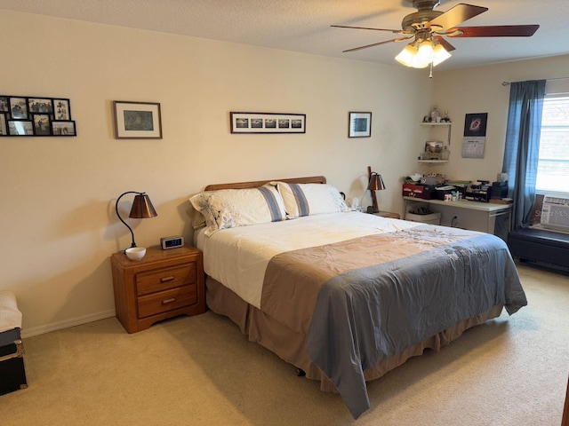 bedroom with light carpet, a textured ceiling, and ceiling fan