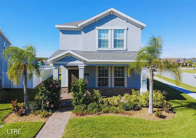 craftsman-style house featuring a front yard