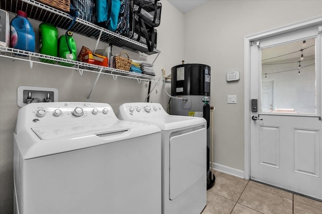 washroom featuring tile patterned flooring, washing machine and clothes dryer, and water heater