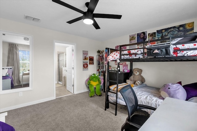 bedroom with light carpet, connected bathroom, and ceiling fan