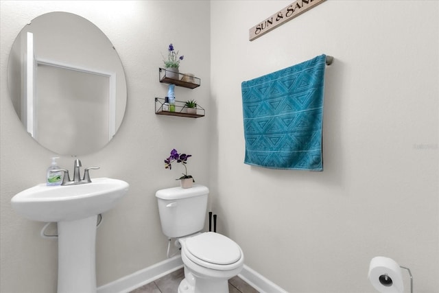 bathroom featuring tile patterned floors and toilet