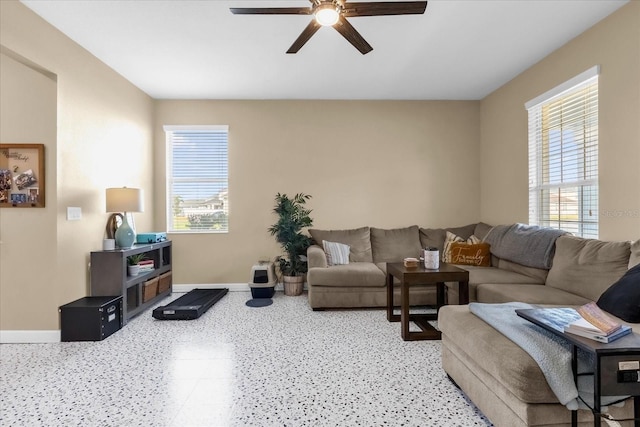 living room featuring plenty of natural light and ceiling fan