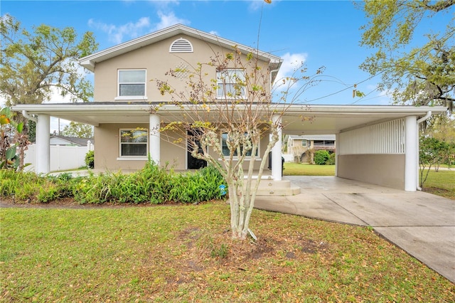 view of front of home with a front lawn and stucco siding