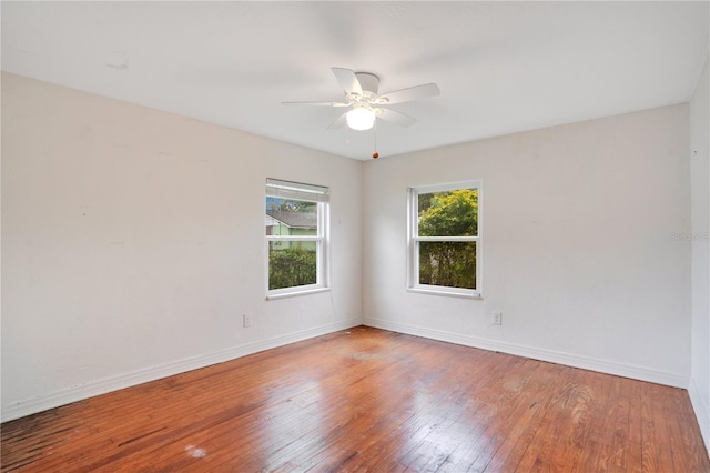 unfurnished room featuring baseboards, wood-type flooring, and ceiling fan