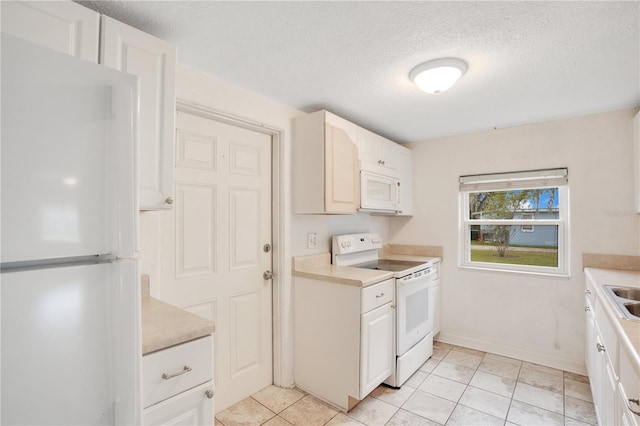 kitchen with white cabinetry, white appliances, a textured ceiling, and light countertops