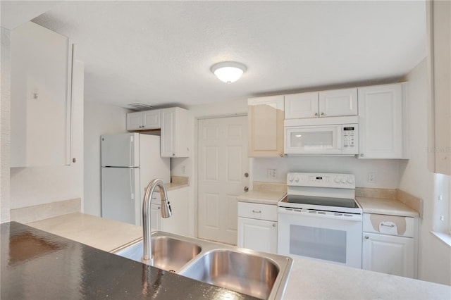 kitchen featuring a sink, white appliances, a textured ceiling, and white cabinetry