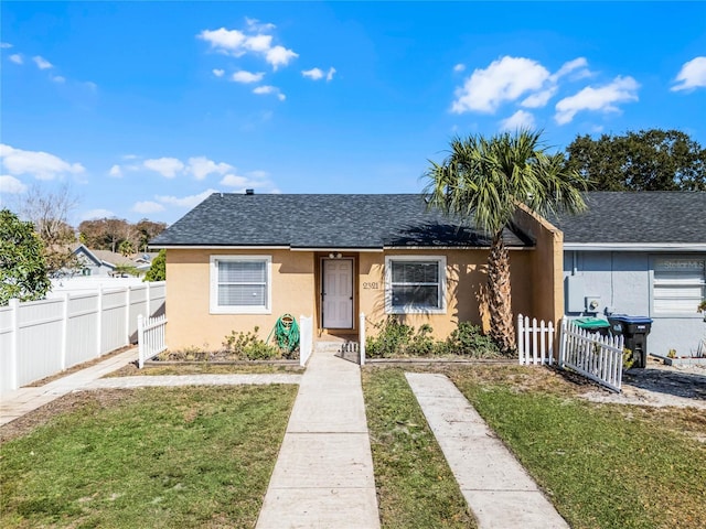 bungalow-style home with a front yard