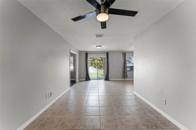 foyer entrance with ceiling fan, a textured ceiling, and light tile patterned floors