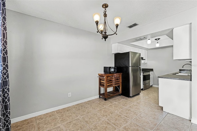 kitchen featuring white cabinetry, sink, a chandelier, a tray ceiling, and stainless steel appliances