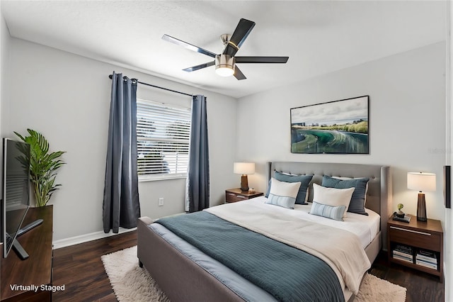 bedroom with dark wood-type flooring and ceiling fan