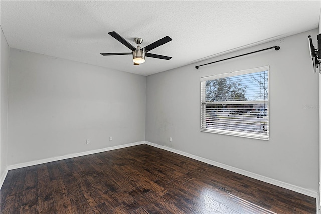 empty room with ceiling fan, wood-type flooring, and a textured ceiling