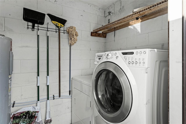 clothes washing area with water heater and washing machine and clothes dryer