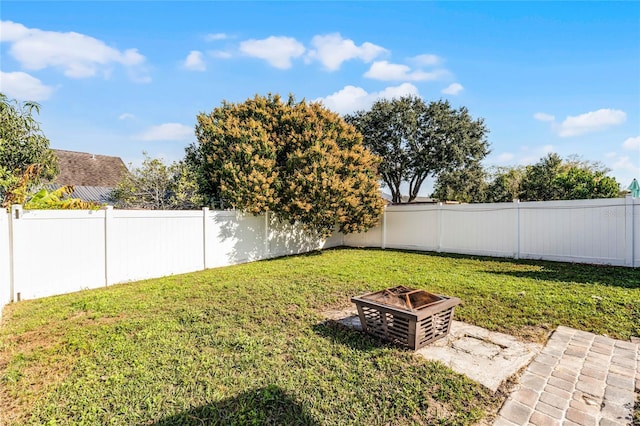 view of yard with an outdoor fire pit