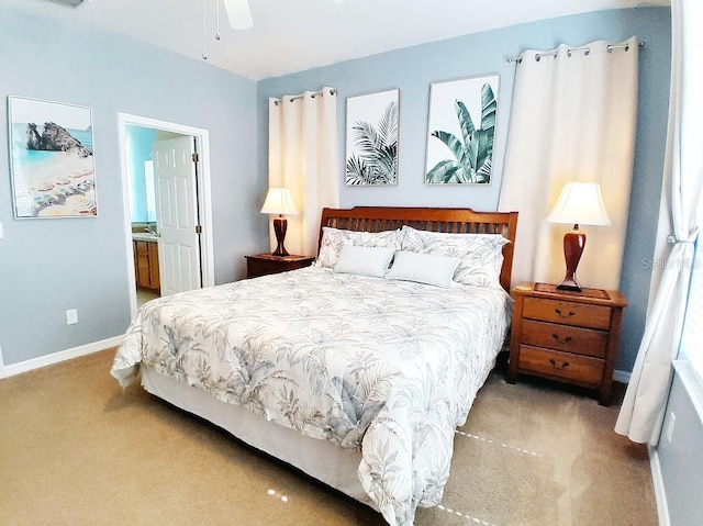 bedroom with ensuite bath and light colored carpet