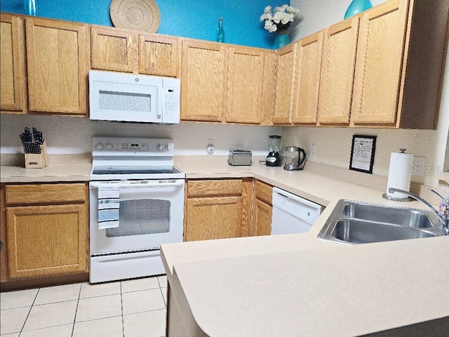 kitchen with white appliances, light brown cabinetry, sink, and light tile patterned floors