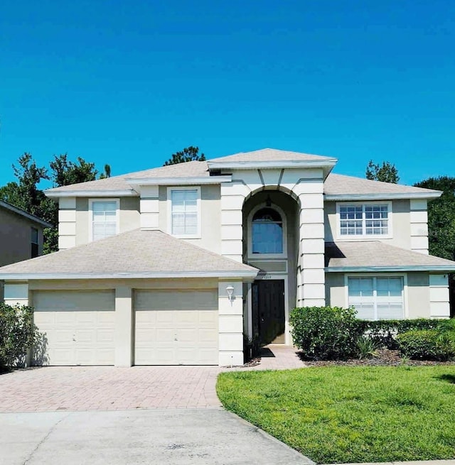 view of front of house with a garage and a front lawn