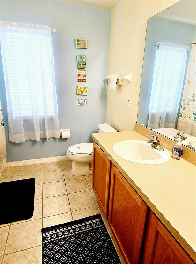 bathroom featuring vanity, tile patterned floors, and toilet