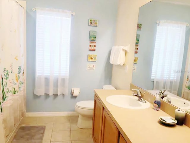 bathroom with tile patterned flooring, vanity, and toilet