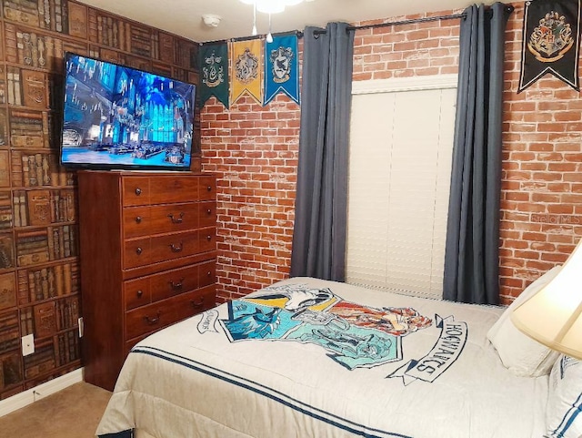 bedroom featuring brick wall