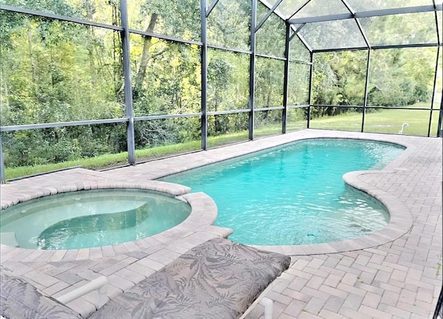 view of pool featuring an in ground hot tub, a lanai, and a patio