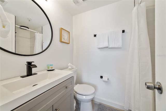 bathroom featuring vanity, toilet, and walk in shower