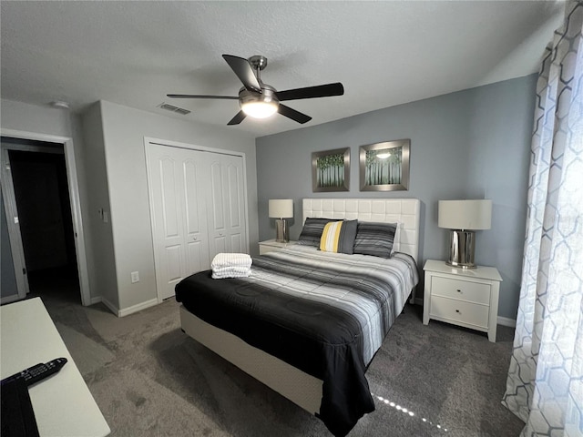 bedroom with dark carpet, a textured ceiling, a closet, and ceiling fan