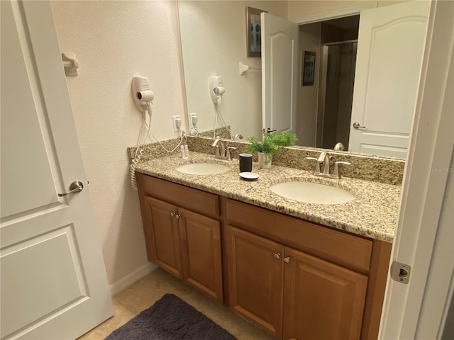 bathroom with tile patterned floors and vanity