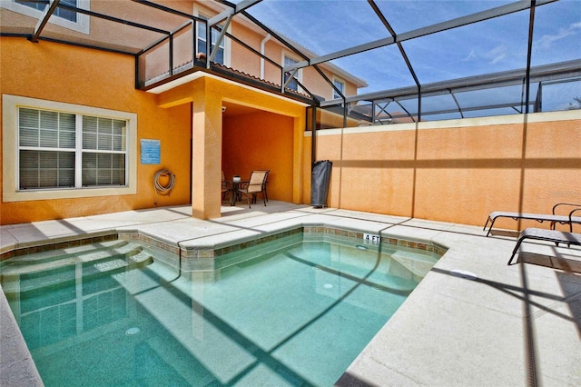 view of swimming pool with a patio and glass enclosure