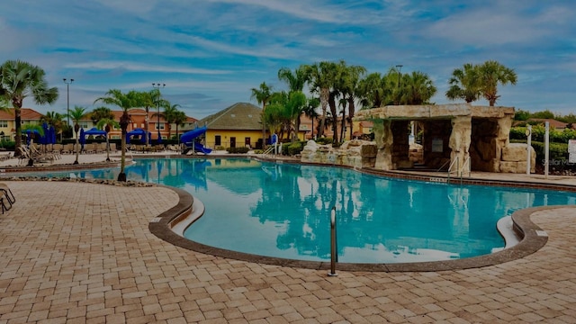 view of pool featuring a water slide and a patio area