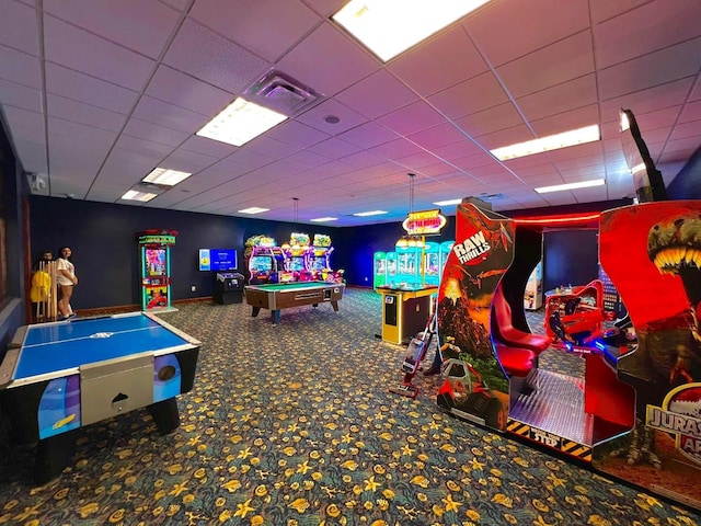 rec room featuring carpet floors and a drop ceiling