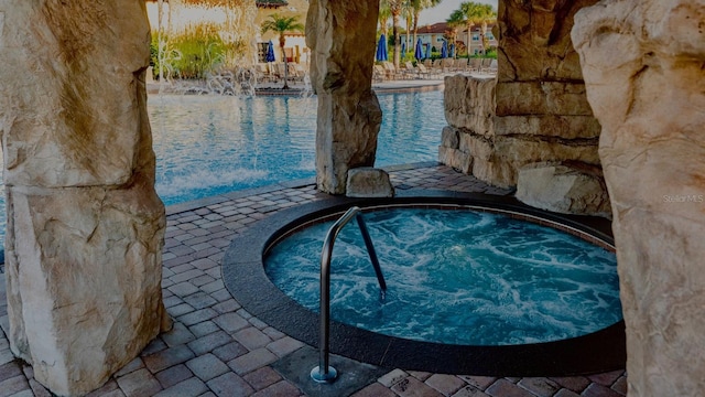 view of pool with a community hot tub