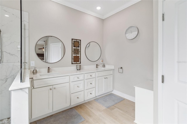 bathroom featuring hardwood / wood-style flooring, vanity, and crown molding