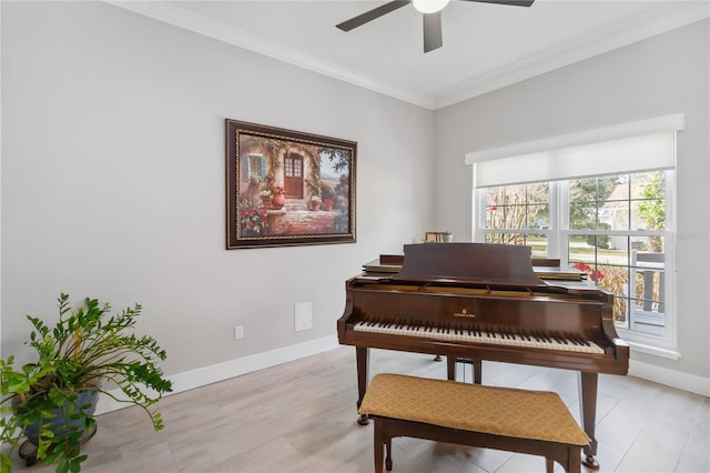 miscellaneous room featuring ceiling fan, ornamental molding, and light wood-type flooring