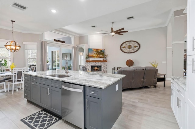 kitchen featuring gray cabinetry, hanging light fixtures, crown molding, and dishwasher