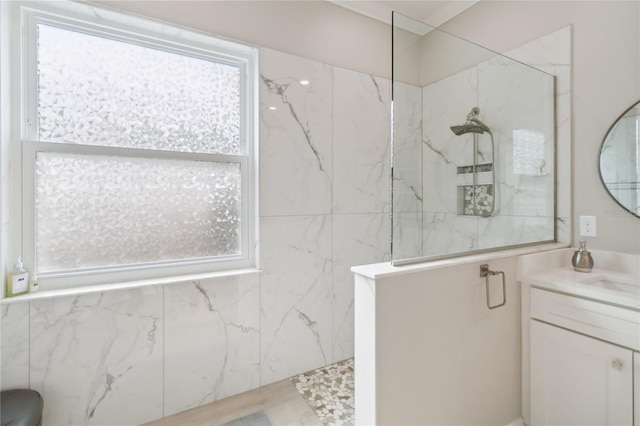 bathroom with vanity, a healthy amount of sunlight, and walk in shower