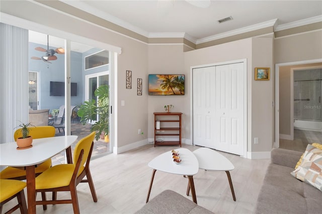 living room with ceiling fan, ornamental molding, and light wood-type flooring